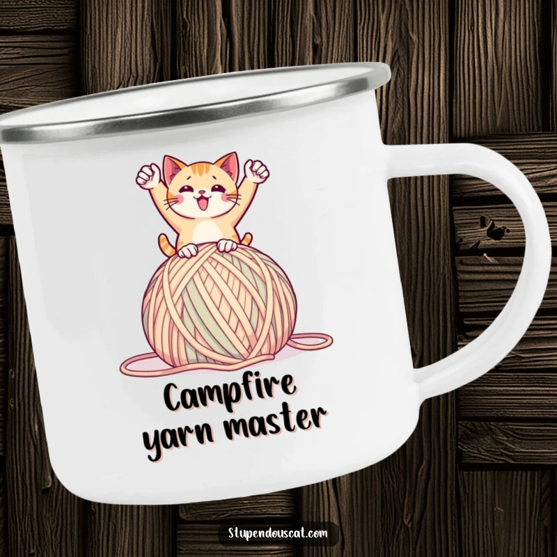 Funny camping mug with a cat in a triumphant pose on a giant ball of yarn, perfect for outdoor celebrations and humor, a unique gift.