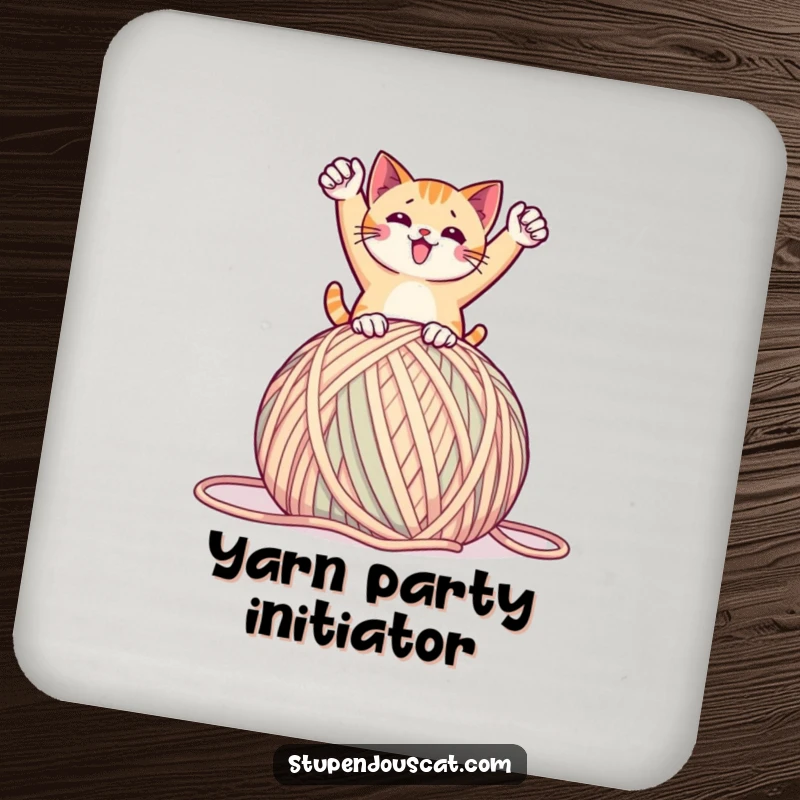 Funny coaster with a cat in a triumphant pose on a giant ball of yarn, offering humorous playful protection, a practical and cute gift.