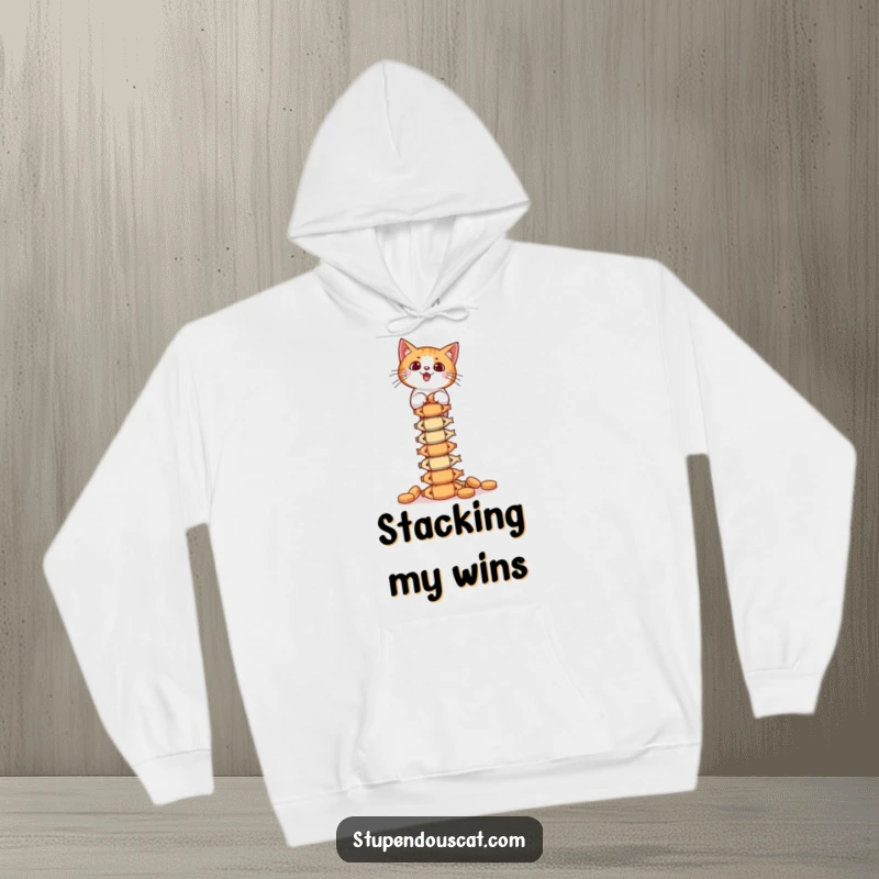 Funny Hoodie: A focused cat balances a towering stack of fish treats, offering warm, comforting humor.