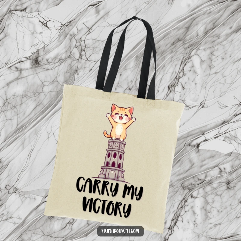 Funny Triumphant Cat Tote Bag: A sturdy tote featuring a cat standing triumphantly atop a challenging, impossible structure.