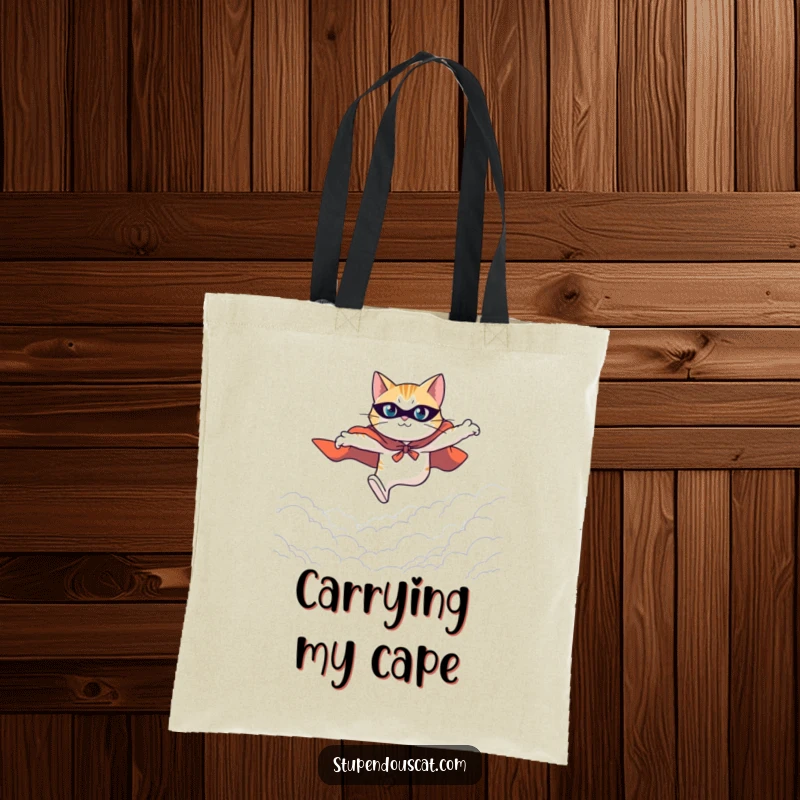 Funny tote bag with a heroic cat in a cape leaping determinedly across a vast expanse, ready for action.