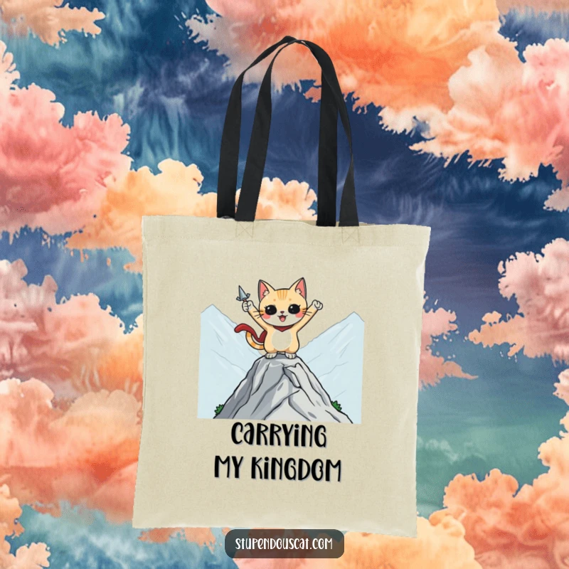 Funny tote bag featuring a heroic cat character striking a pose on a mountaintop, ideal for carrying items on adventures.